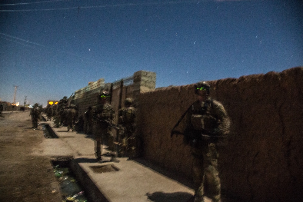 Coalition force members provide security during Helmand province operation