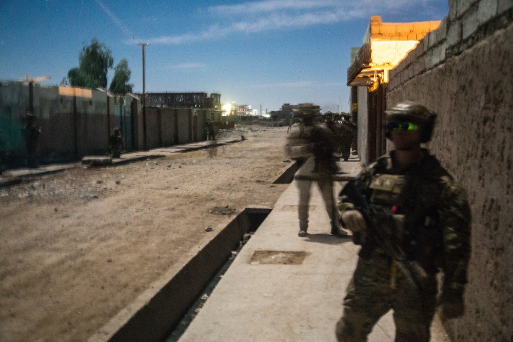 Coalition force members provide security during Helmand province operation