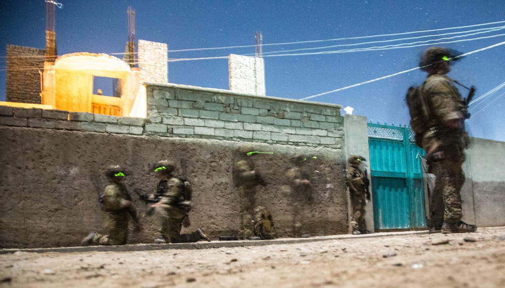 Coalition force members provide security during Helmand province operation