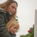 Family places Christmas wreath on grave marker of fallen hero