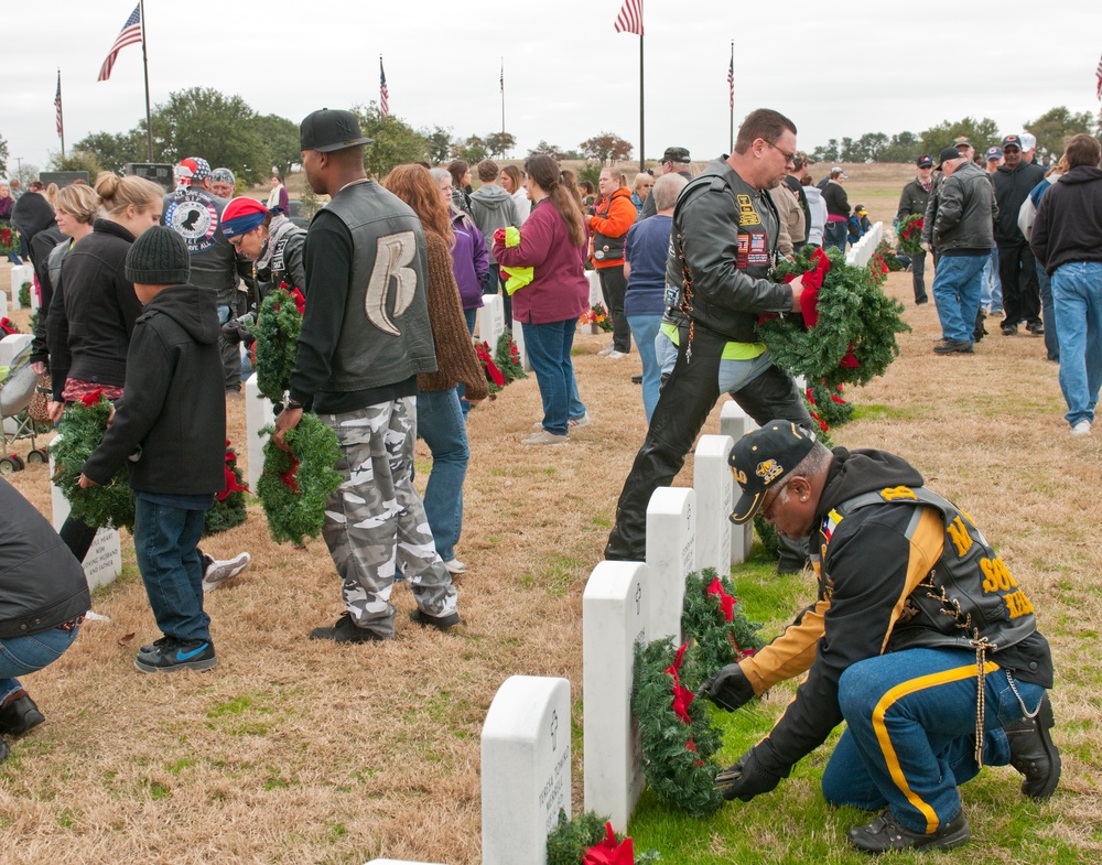 Veterans from all walks of life place Christmas wreaths for fallen heroes