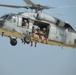 Navy Desert Hawk carrying a chalk of FAST Marines