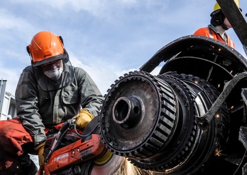 Airman cuts engine with saw