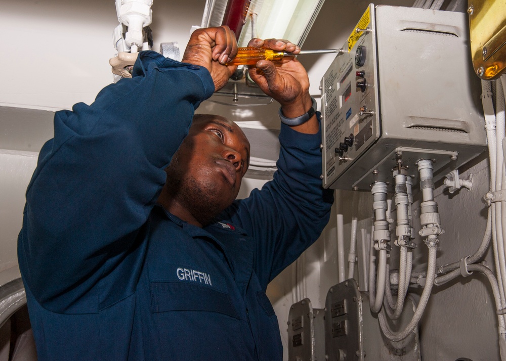 USS Harry S. Truman sailor conducts diagnostics