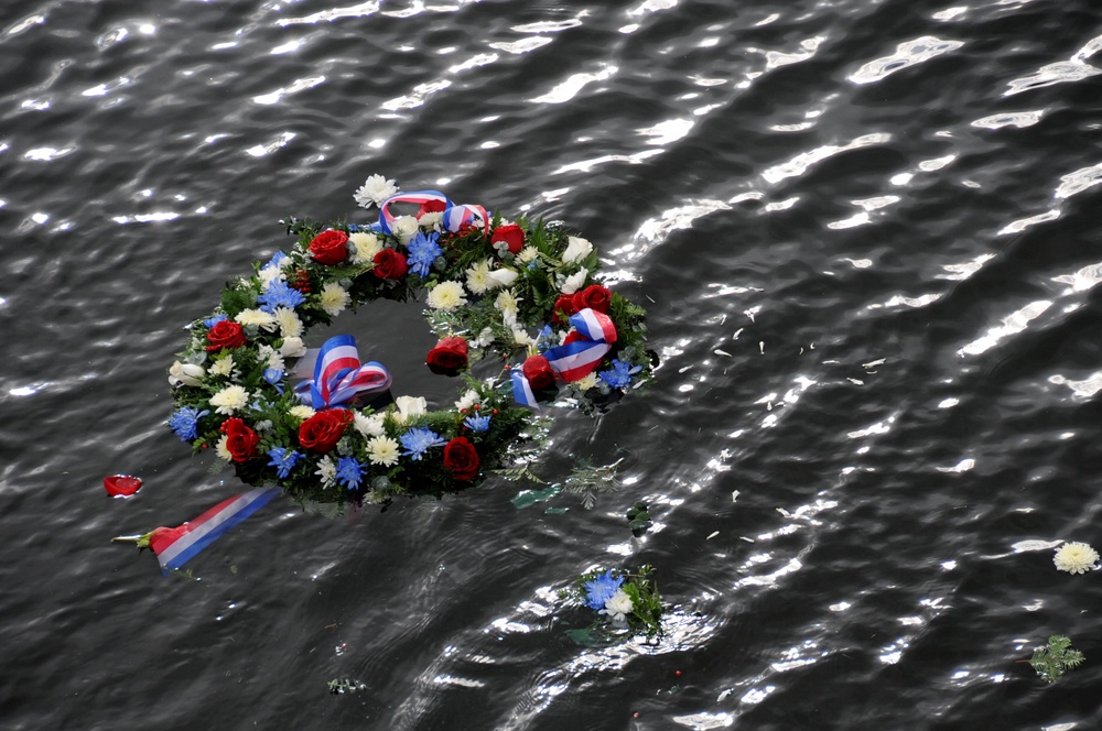 Ceremonial wreath laid in the water during Pearl Harbor memorial ceremony