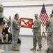 Command Sgt. Maj. Anthony F. Mainiero is presented with a guidon from the 213th Regional Support Group