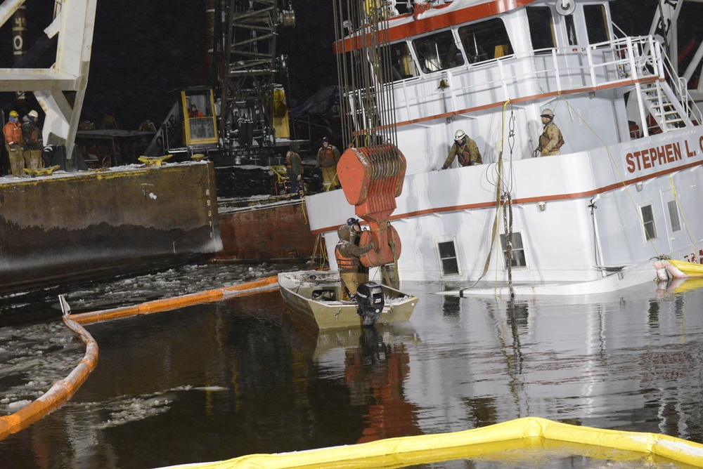 Response crews rig sling to Stephen L. Colby in snowy conditions