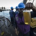 Sailor inspects fuel during replenishment