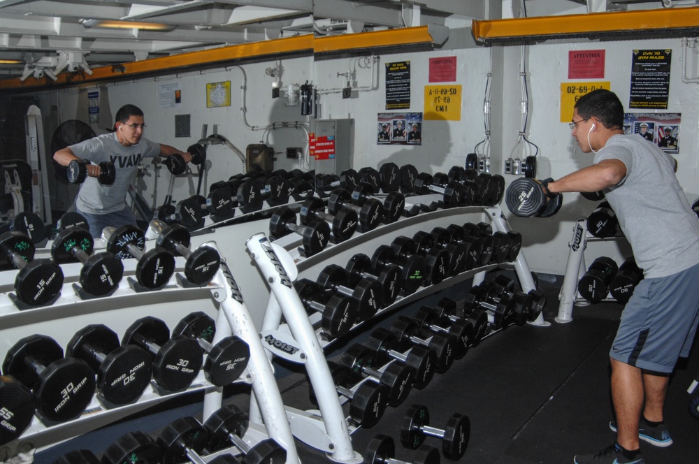 USS Carl Vinson sailor lifts weights