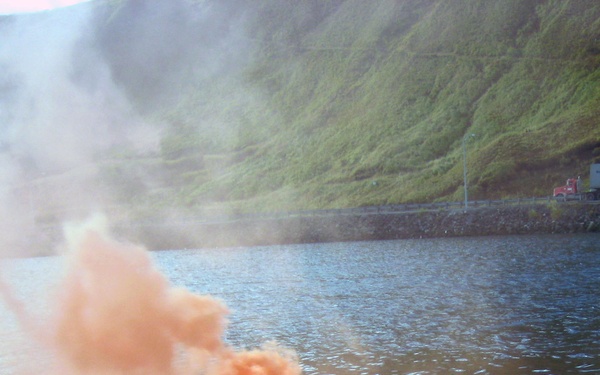 Alaska crab fisherman lighting off a smoke flare