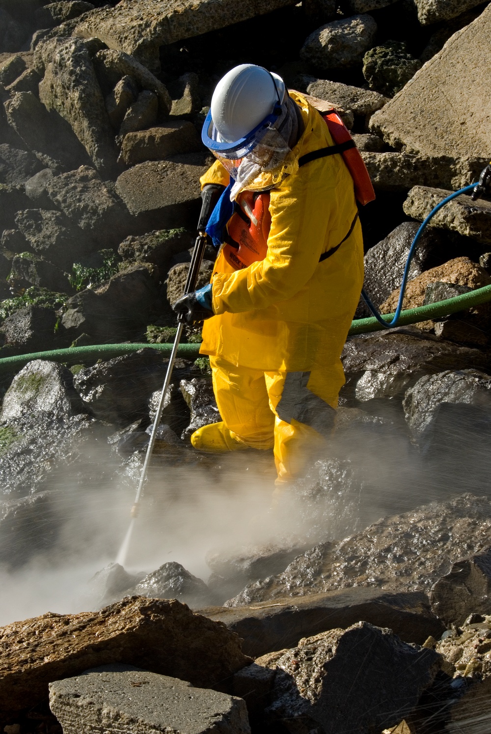 Cleanup Crews Conduct High-Pressure Wash