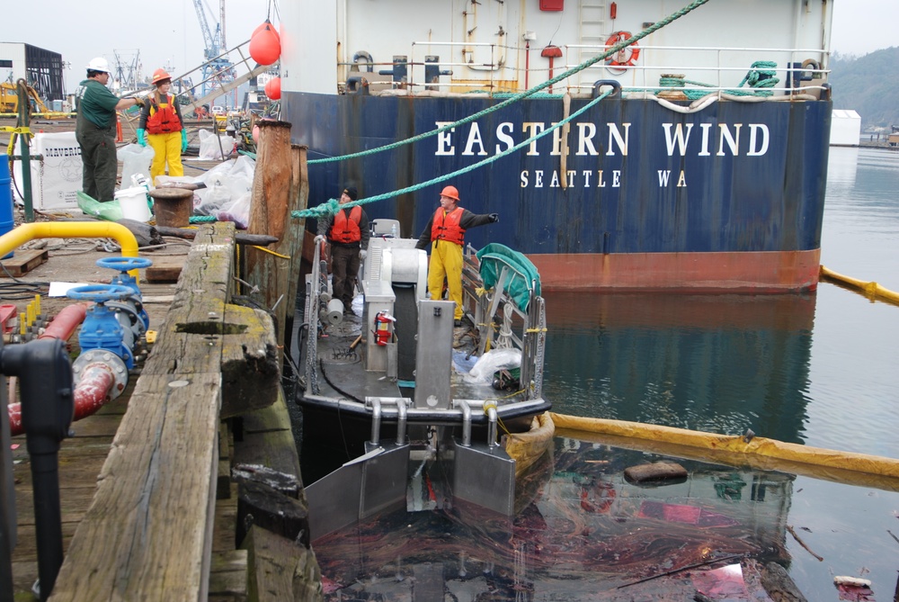 National Response Corporation Environmental Services skims and booms oil spill