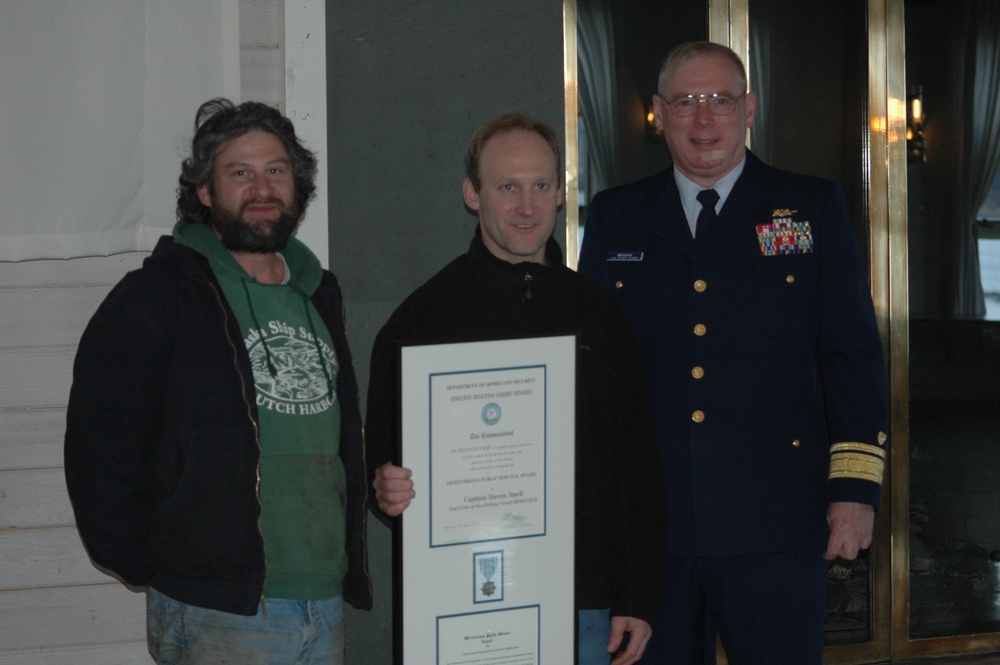 Steven Stark and Bret Haynes hold the Coast Guard Meritorious Public Service Award