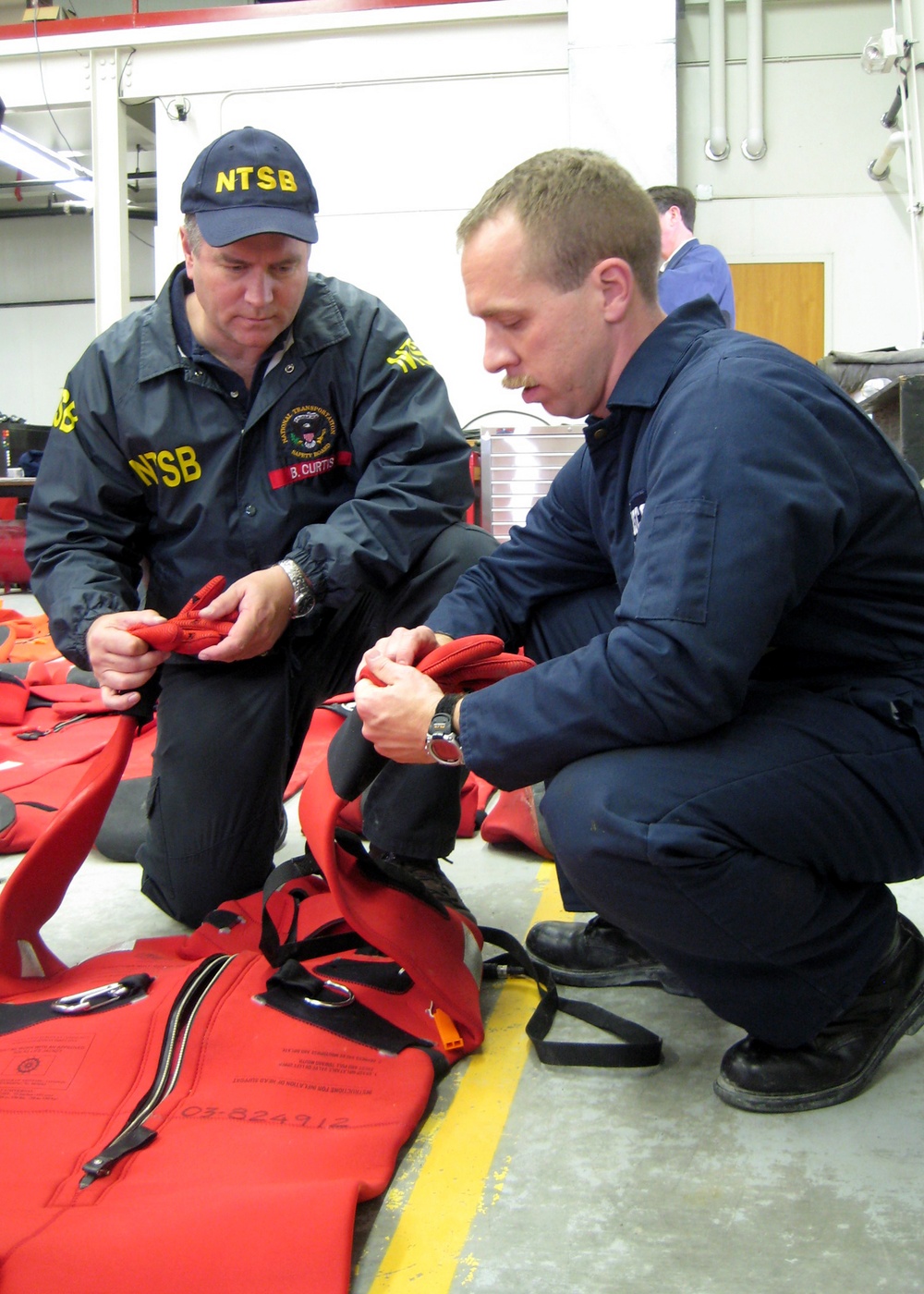COAST GUARD, NTSB MEMBERS OF MARINE BOARD OF INVESTIGATION INSPECT ALASKA RANGER SURVIVAL SUITS
