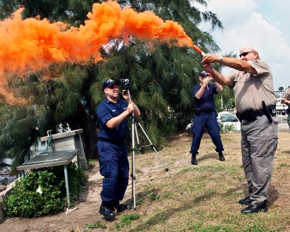 Florida Fish and Wildlife Officer Jack Salafia demonstrates a smoke flare while Zack Lessin films a training video