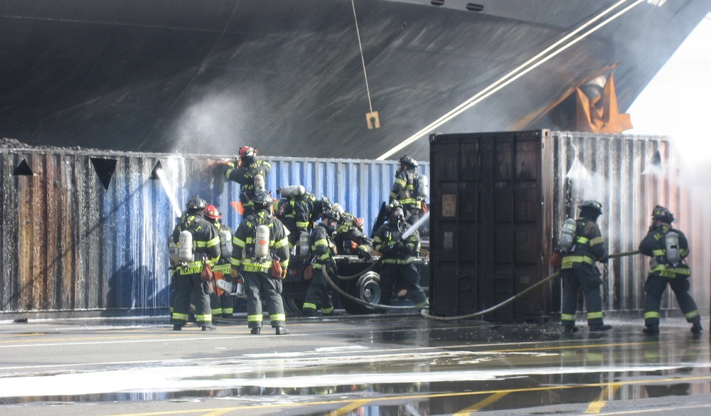 Firefighters douse a smoldering cargo container
