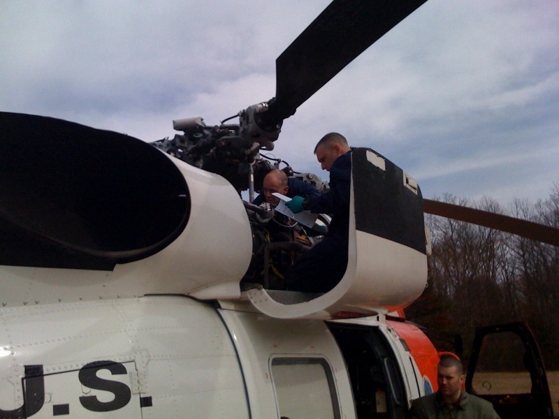 Coast Guard crew works on helicopter