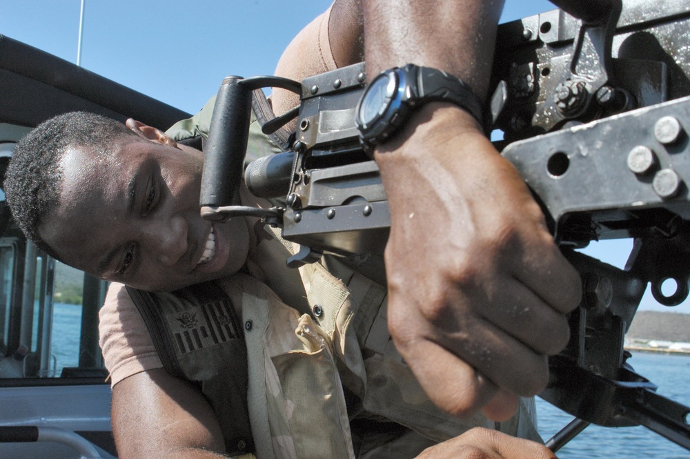 Repairing a Machine Gun on Patrol in Guantanamo Bay, Cuba