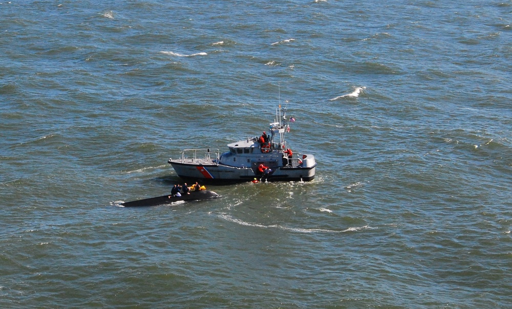 Men rescued off capsized vessel