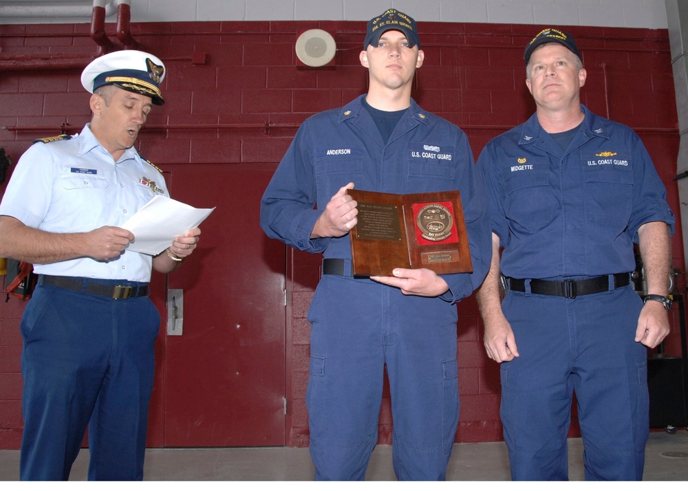 Capt. Theodore Harrop recognizes BM2 Anderson for Cmdr. Raymond Evans Outstanding Coxswain Trophy