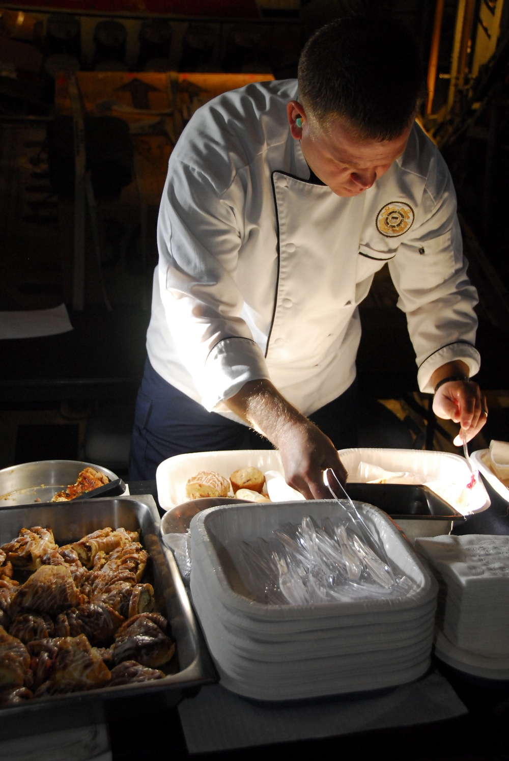 Chief Warrant Officer Brian Marshall serves brunch aboard a C-130 Hercules aircraft
