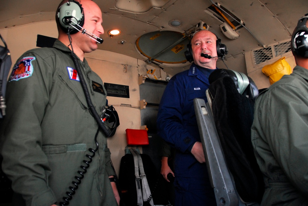 Adm. Thad Allen, Coast Guard Commandant, discusses aircraft operations with Petty Officer Matt Overmyer aboard a C-130 Hercules