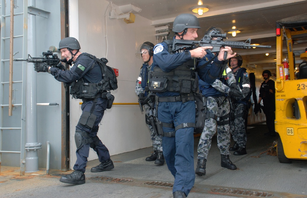 Joint U.S. and Australian navy boarding team conduct security sweep