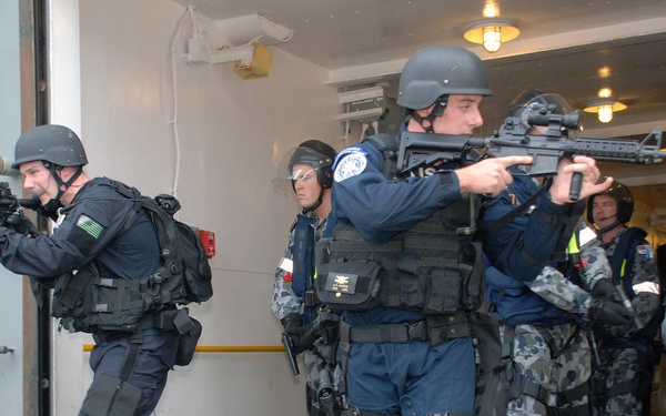 Joint U.S. and Australian navy boarding team conduct security sweep