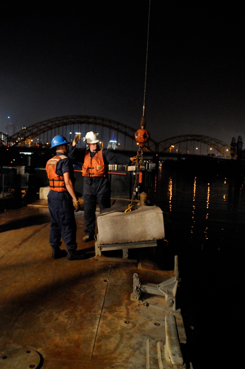 Osage crewmembers set buoys in preparation for Pittsburgh Summit