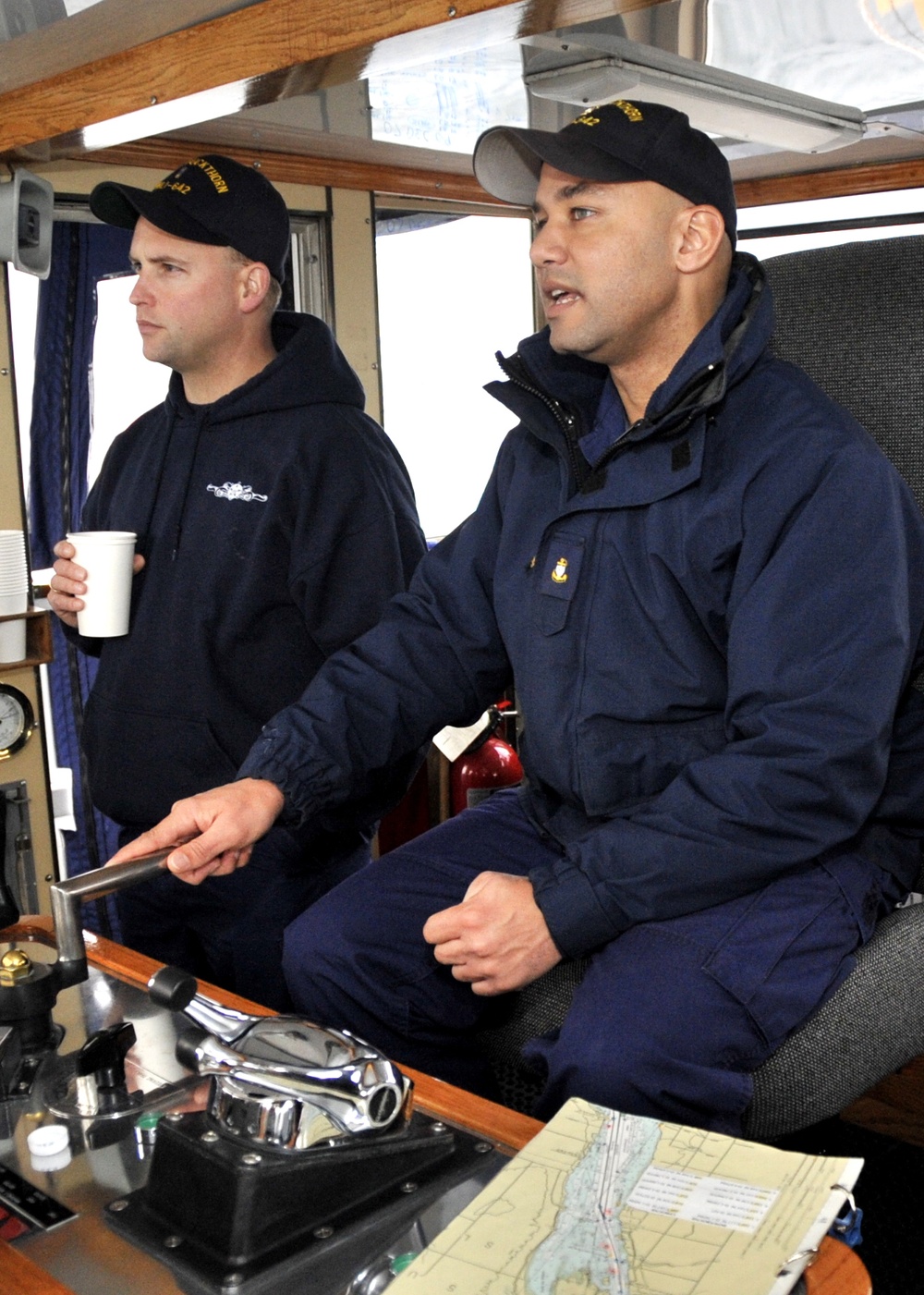 USCGC Buckthorn crew members move buoys