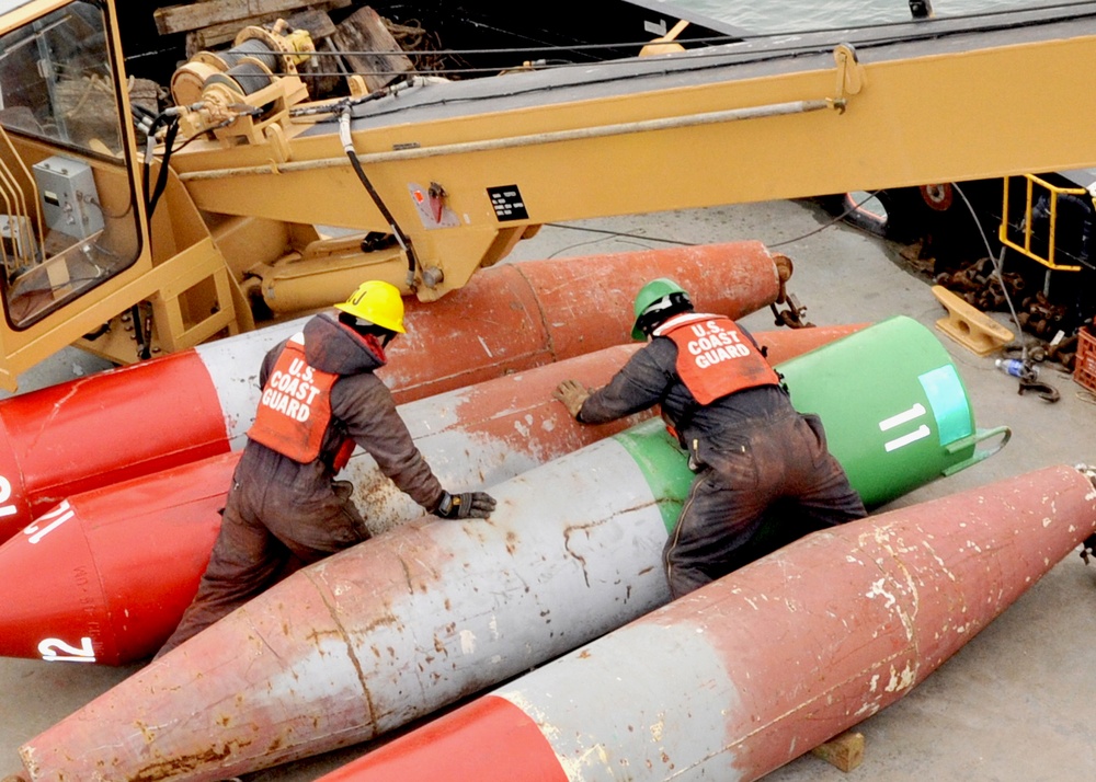 USCGC Buckthorn crew members move buoys