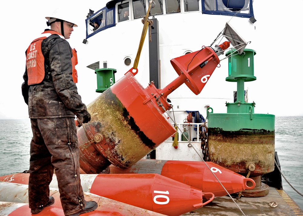 USCGC Buckthorn crew members move buoys