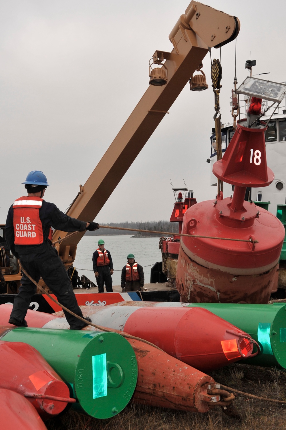 USCGC Buckthorn crew members move buoys