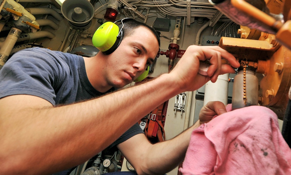 Coast Guard Cutter Oak crewmember collects oil samples