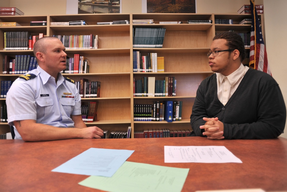 Coast Guard volunteers with high school