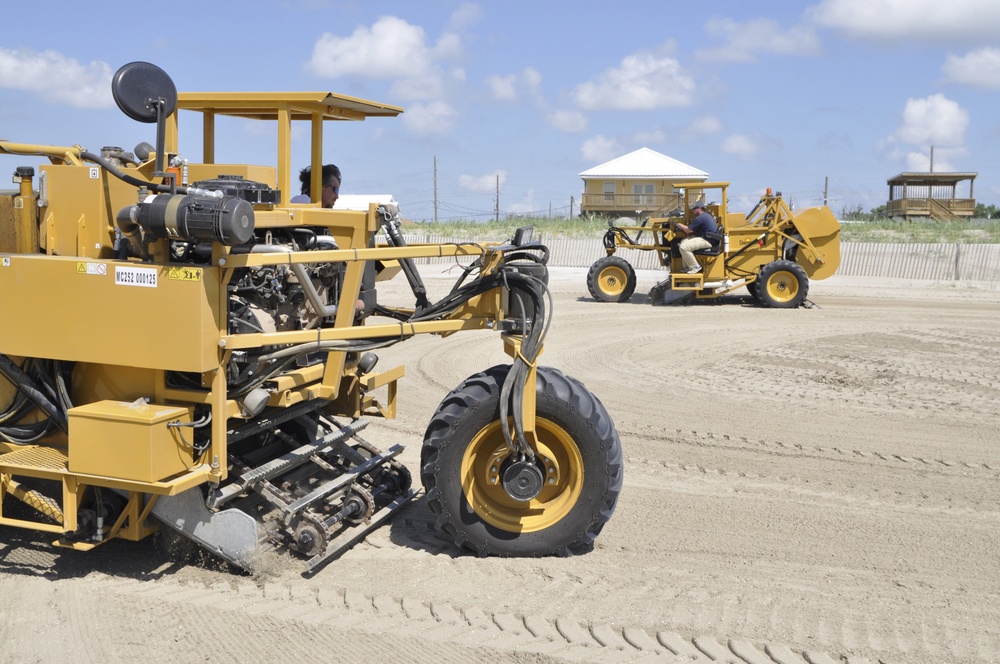 Sand Sweeper machines on beach at Grand Isle, La.