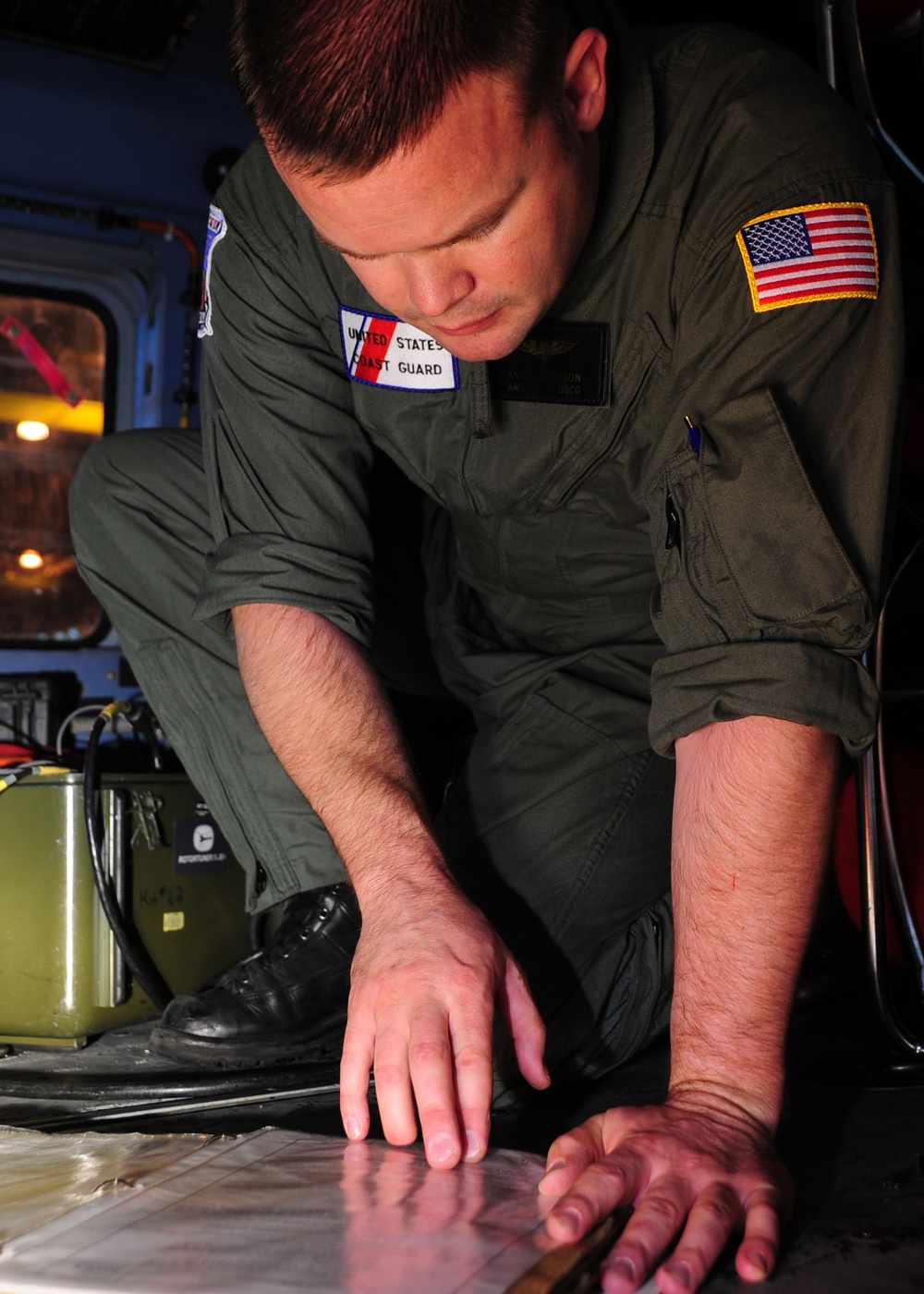 Kodiak-based Air Station MH-60 Jayhawk helicopter crewman conducts maintenance check list