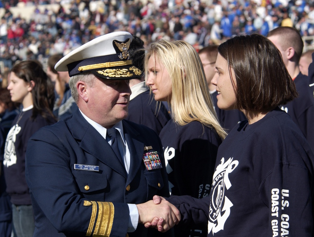 Rear Adm. Joel Whitehead, District 8 Commander congratulates a new Coast Guard recruit ( FOR RELEASE)