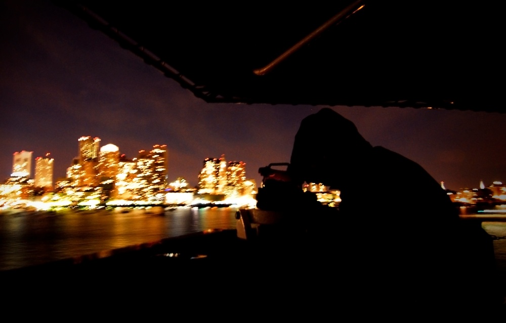 Coast Guard Petty Officer 2nd Class Joshua Scheidell uses an allidade