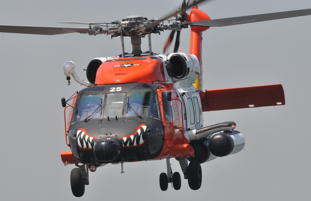 HH60 helicopter from Coast Guard Air Station Cape Cod bows to crowds watching seacrh and rescue demonstration