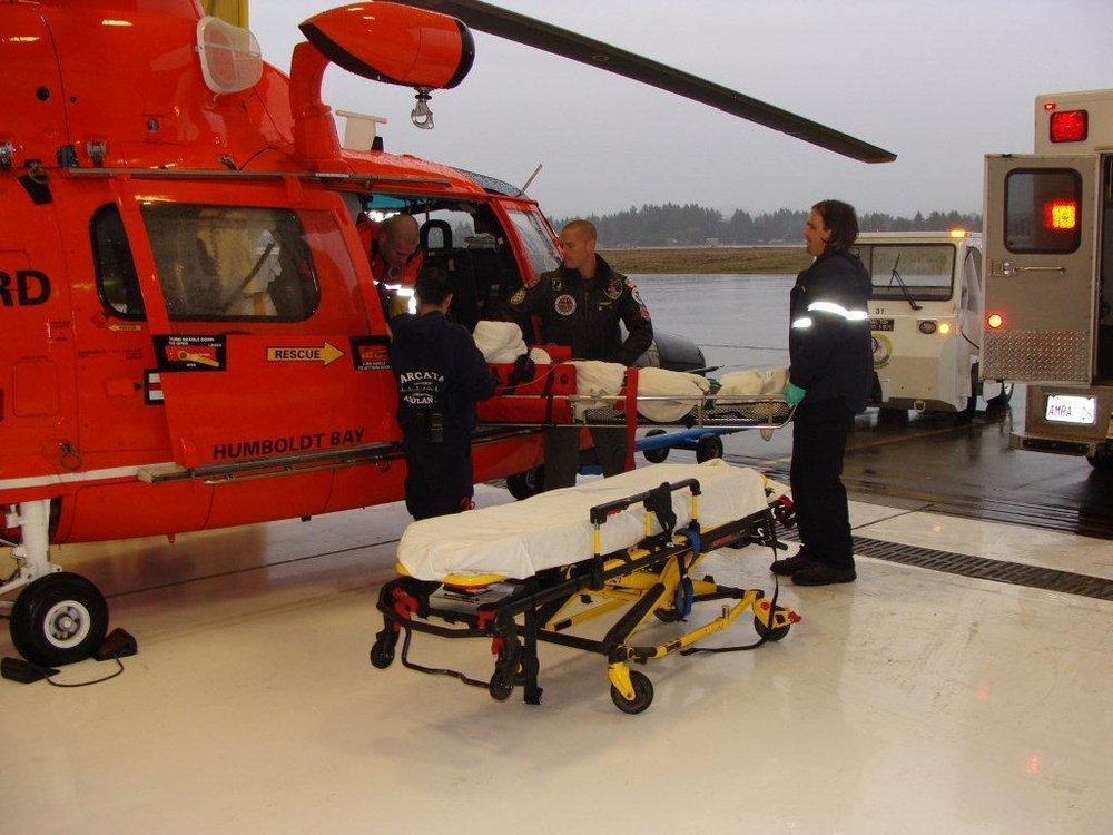 Aircrew transfers injured M/V Columbia crewmember to waiting EMS personnel