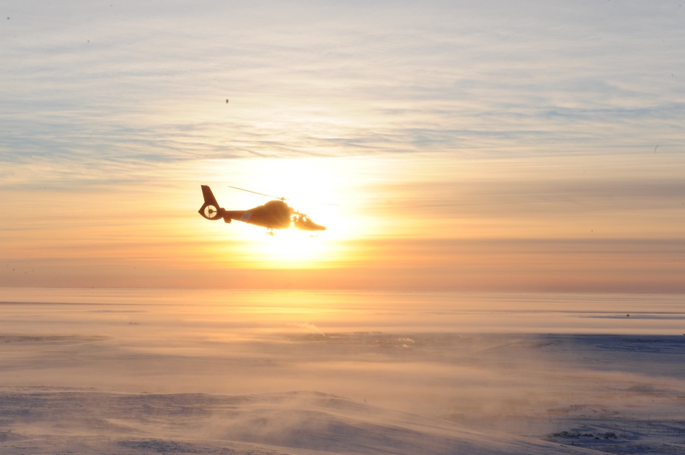 MH-65 Dolphin ascends from a mountain