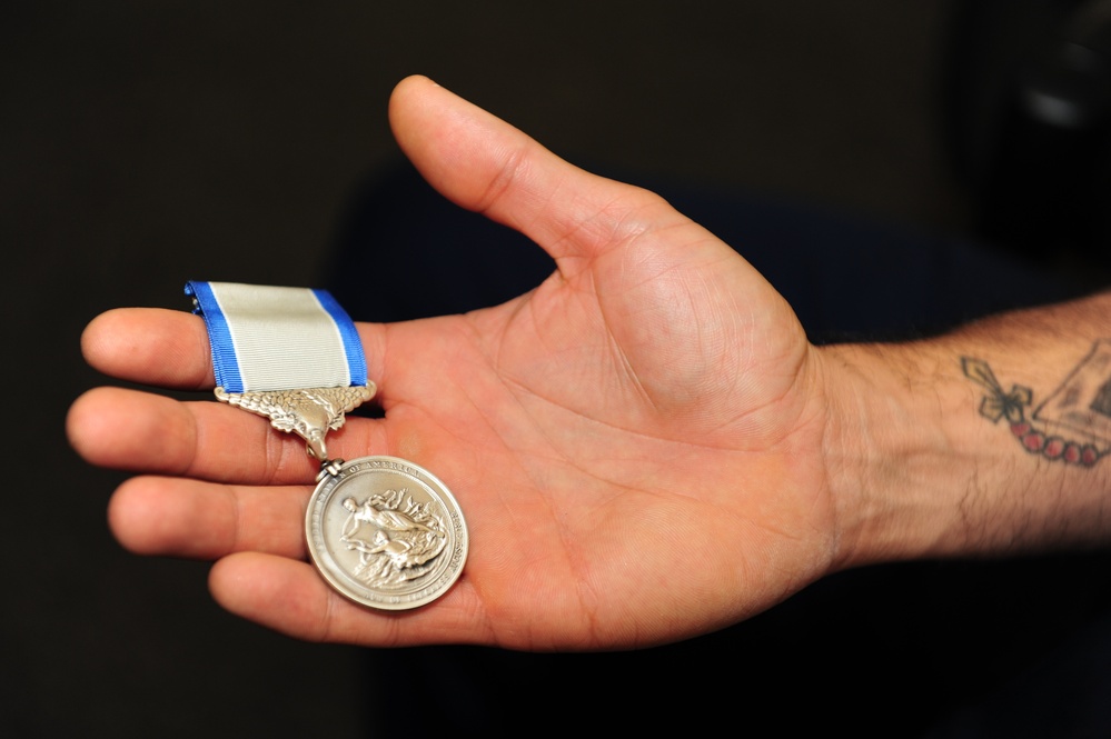 Silver Lifesaving Award In Hand