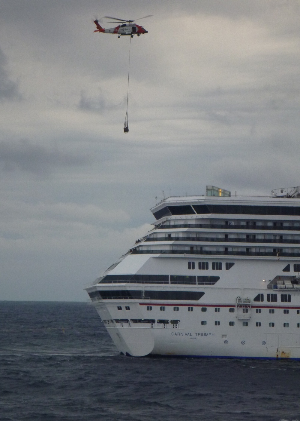 Coast Guard helicopter crew delivers supplies to Cruise Ship Triumph