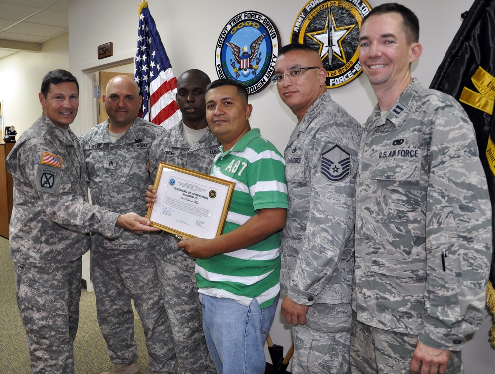 Joint Task Force-Bravo members and Honduran citizen render aid to vehicle accident victim