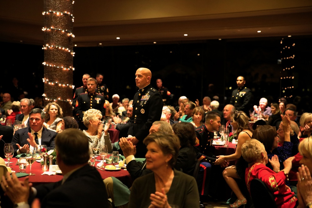 Service members from different bases meet during Toys for Tots dinner