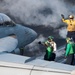 Sailors guide an EA-18G Growler