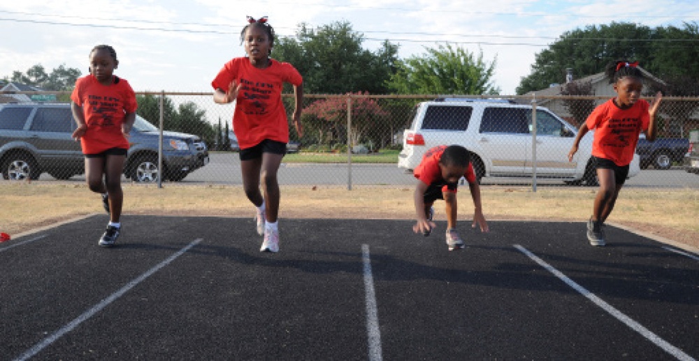 Local Marine recruiter gives back by coaching youth track club