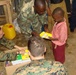 Marines and RSLAF members handing out donated school supplies.