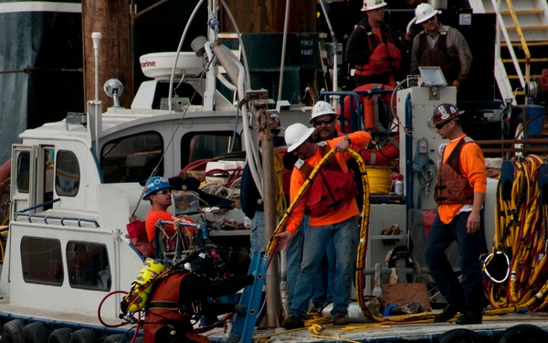 Diver prepares the sunken tug Respect for removal